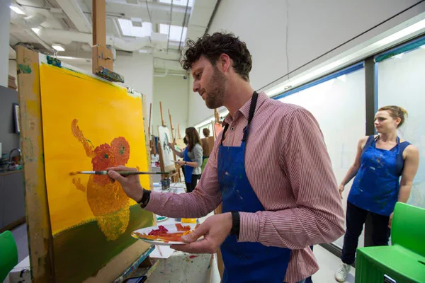 Een bezoeker tijdens een schilderworkshop